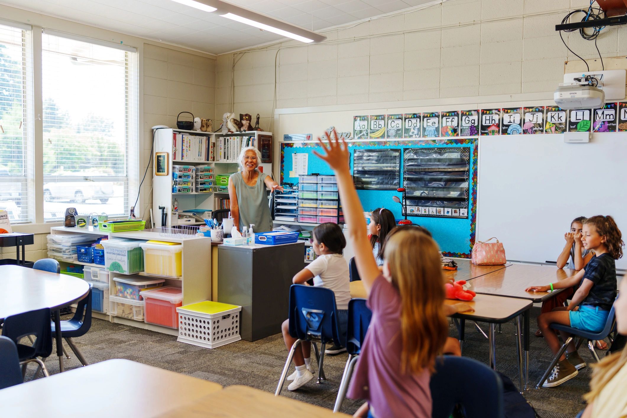 Teacher answering student questions during class