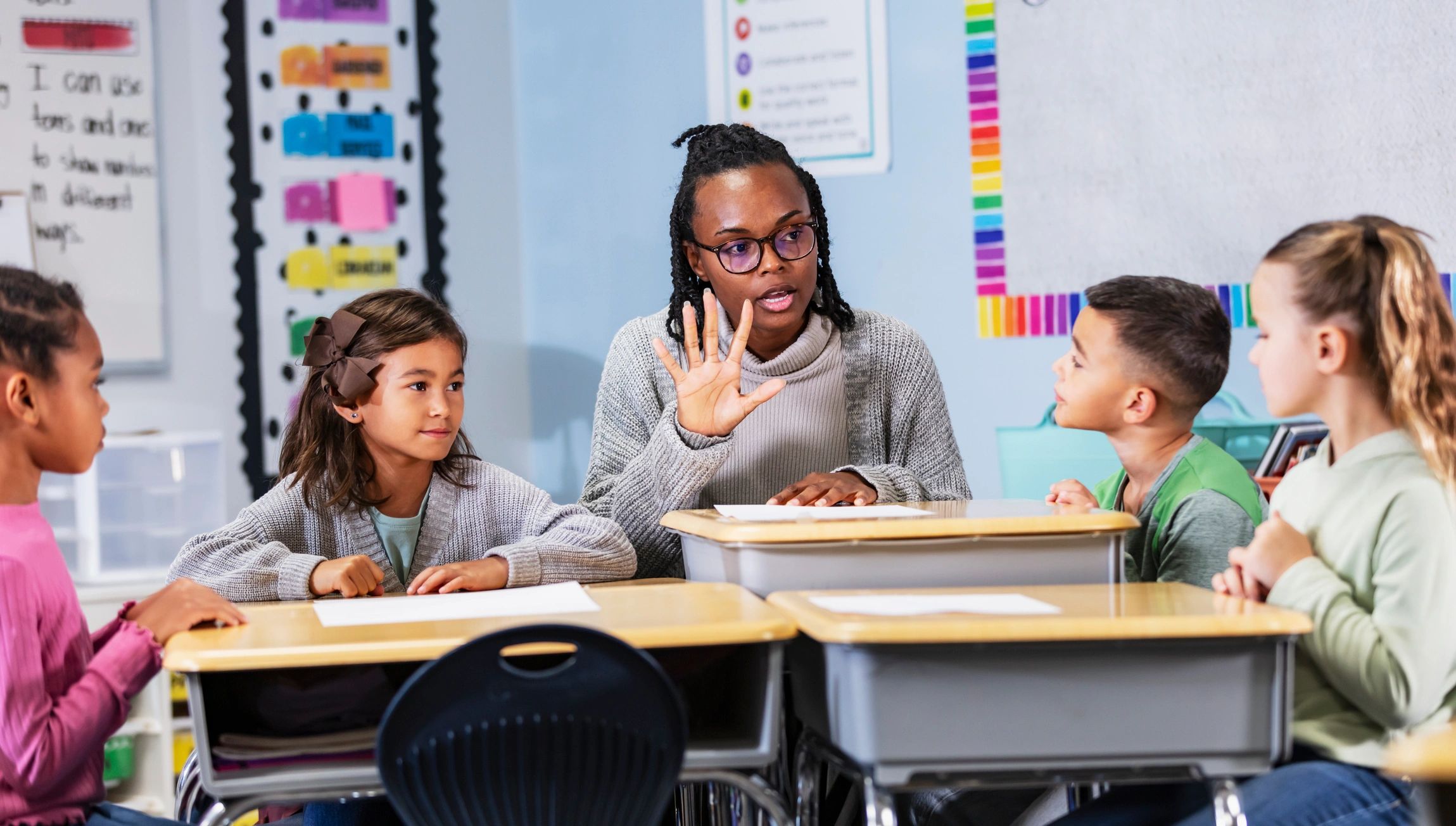 Teacher leading a small group lesson with elementary students