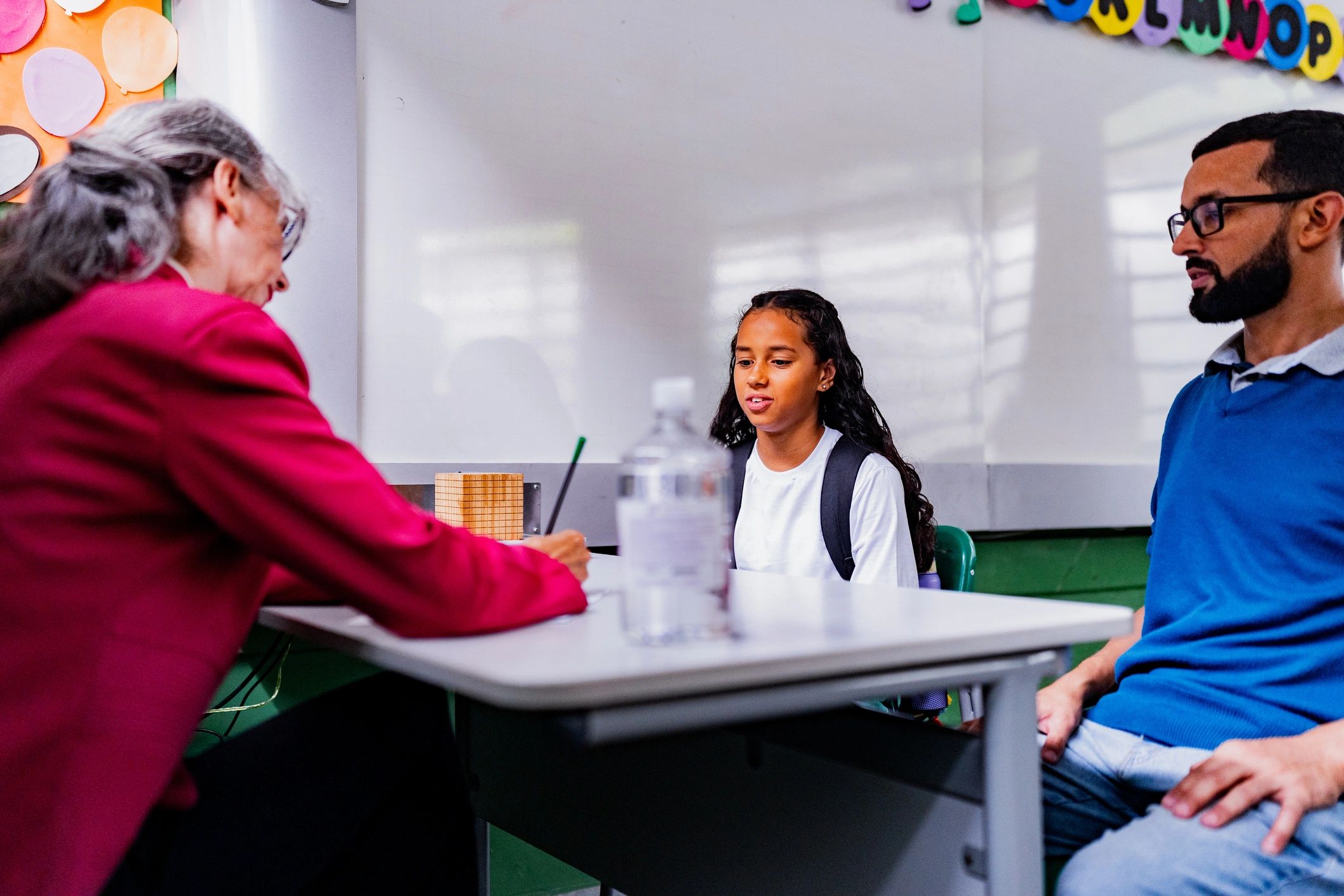 Parent and school staff talking together in a school setting