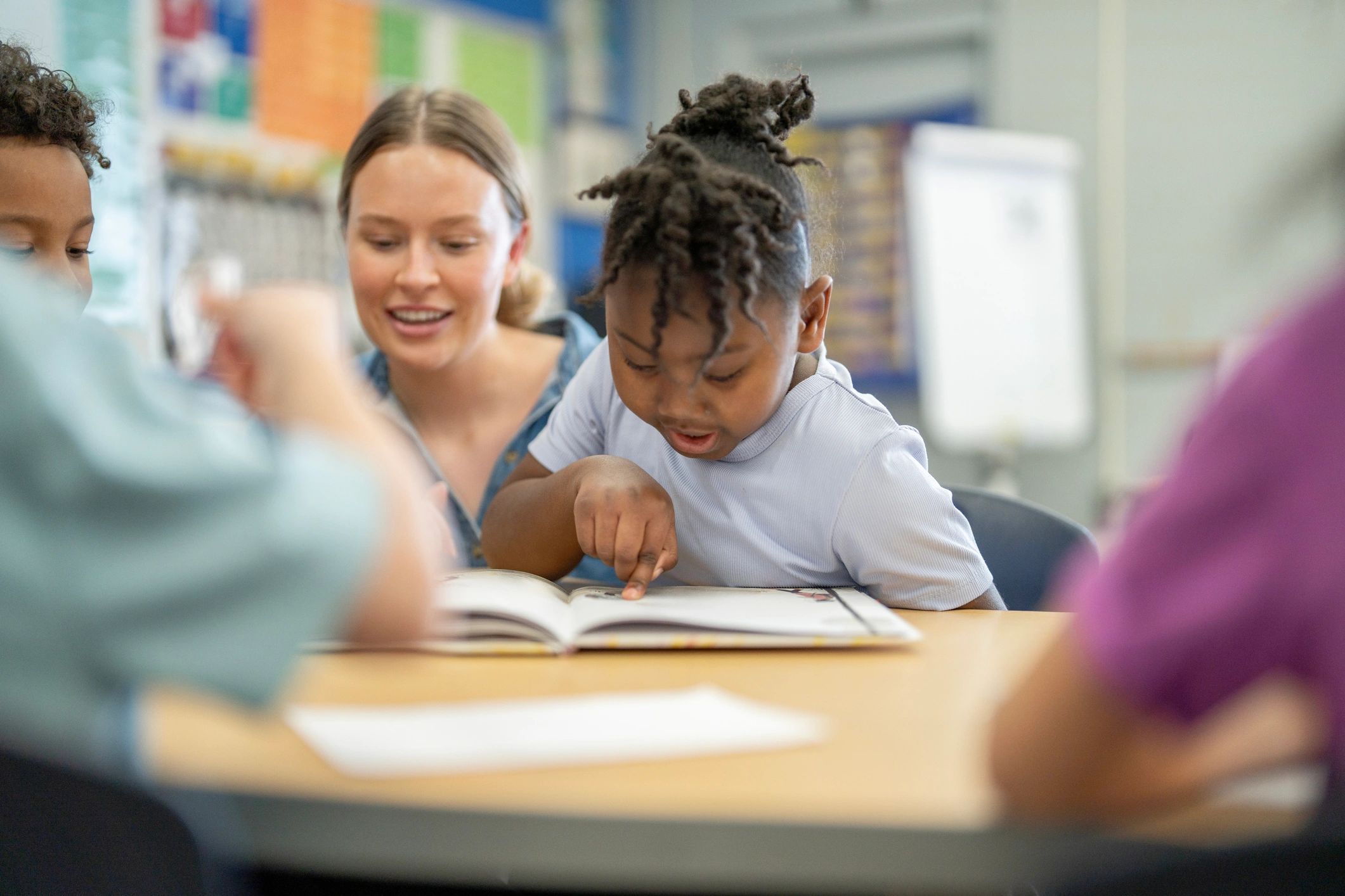 Teacher reading with young students in a classroom