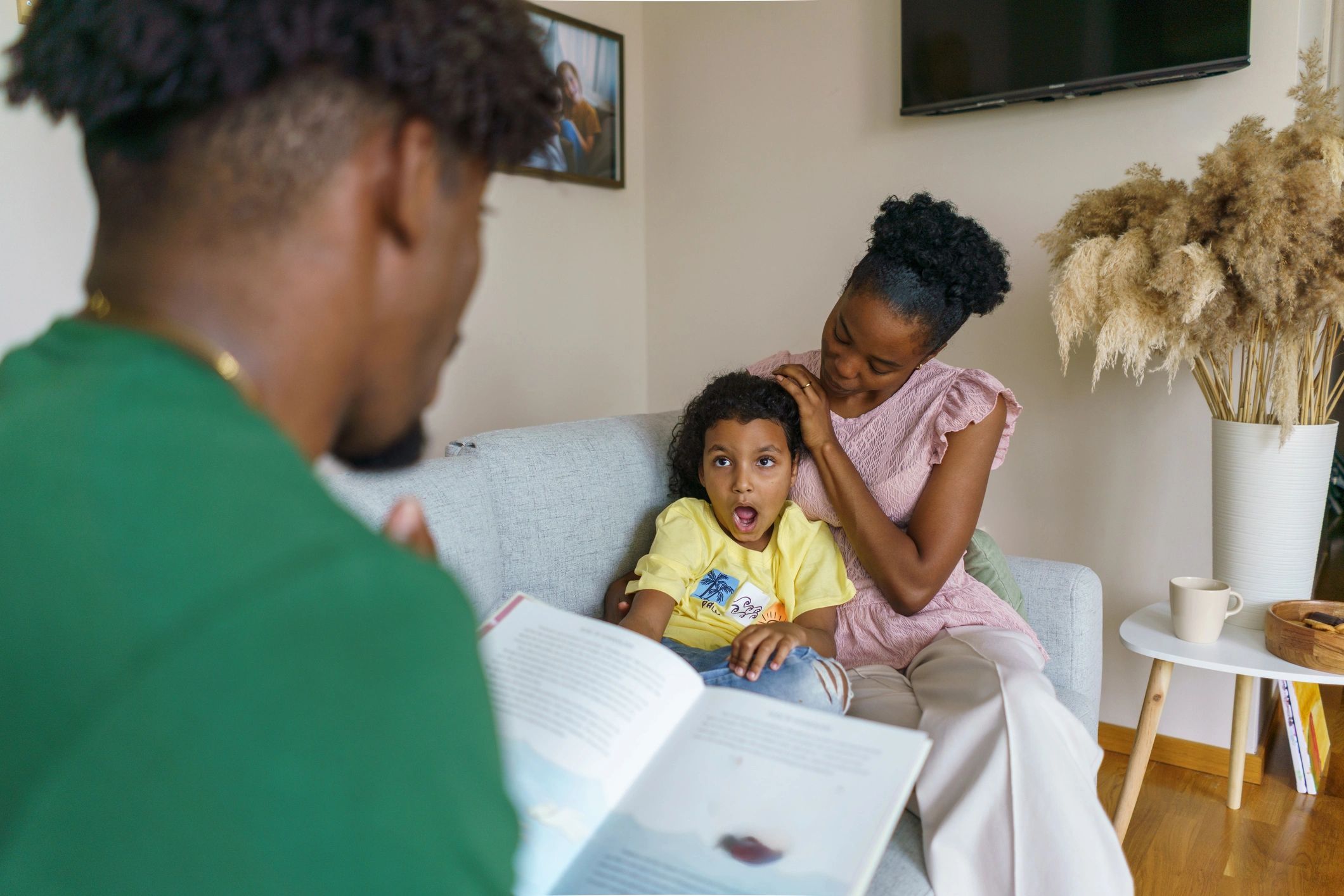 Family reading together at home